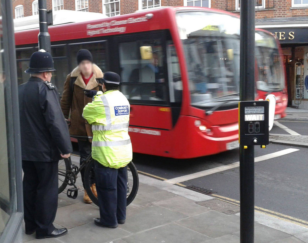 Street scene with police and cyclist